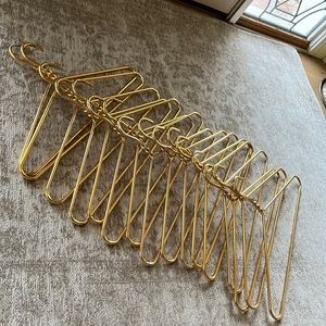 Mid-Century heavy-duty gold tone aluminum clothes hangers 17in across bottom.